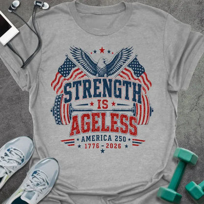 Sport grey t-shirt printed with "Strength is Ageless America 250 1776 - 2026" in red and blue, with an eagle, American flags, and dumbbell