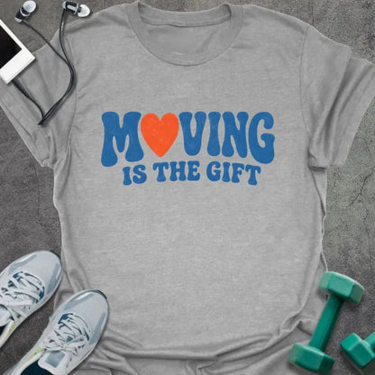 Sport Grey t-shirt printed with "MOVING IS THE GIFT" in blue and orange text with a heart replacing the O
