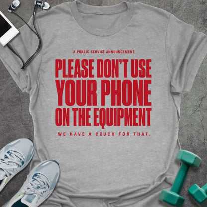 Sport grey t-shirt printed with "A Public Service Announcement Please Don't Use Your Phone on the Equipment We Have a Couch for That." in red