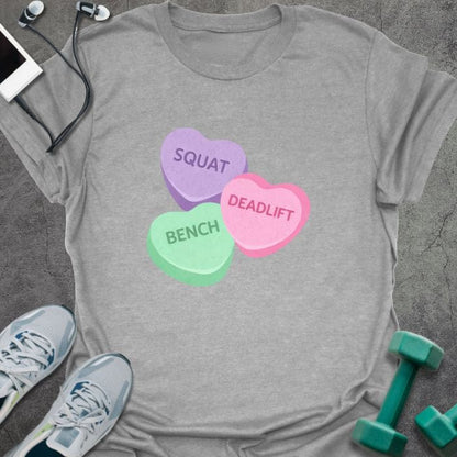 Sport grey t-shirt printed with "Squat Bench Deadlift" in purple, green, pink, with three conversation candy hearts in purple, green, and pink