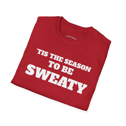 Folded cherry red t-shirt printed with "'TIS THE SEASON TO BE SWEATY" in white