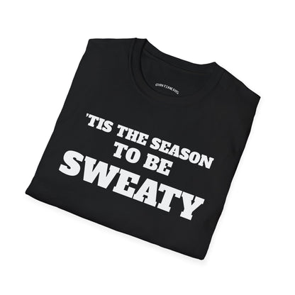 Folded black t-shirt printed with "'TIS THE SEASON TO BE SWEATY" in white