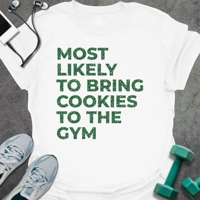 White t-shirt printed with "MOST LIKELY TO BRING COOKIES TO THE GYM" in green