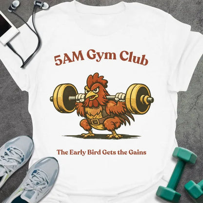 White t-shirt printed with "5AM Gym Club The Early Bird Gets the Gains" in red and brown, with rooster lifting barbell graphic