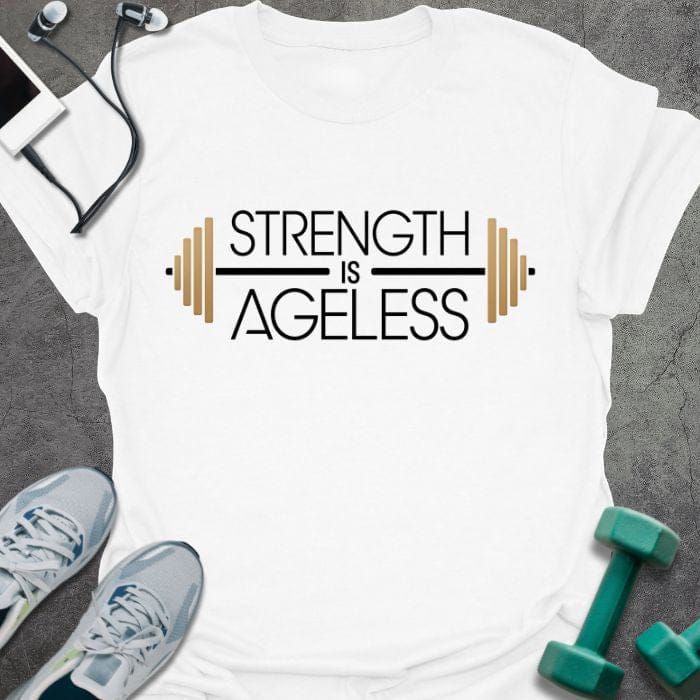 White t-shirt printed with "Strength is Ageless" in yellow and blue, with barbell illustration