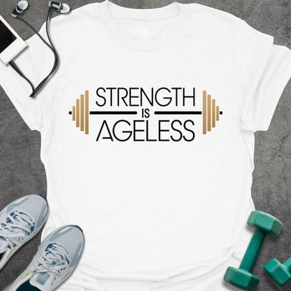 White t-shirt printed with "Strength is Ageless" in yellow and blue, with barbell illustration