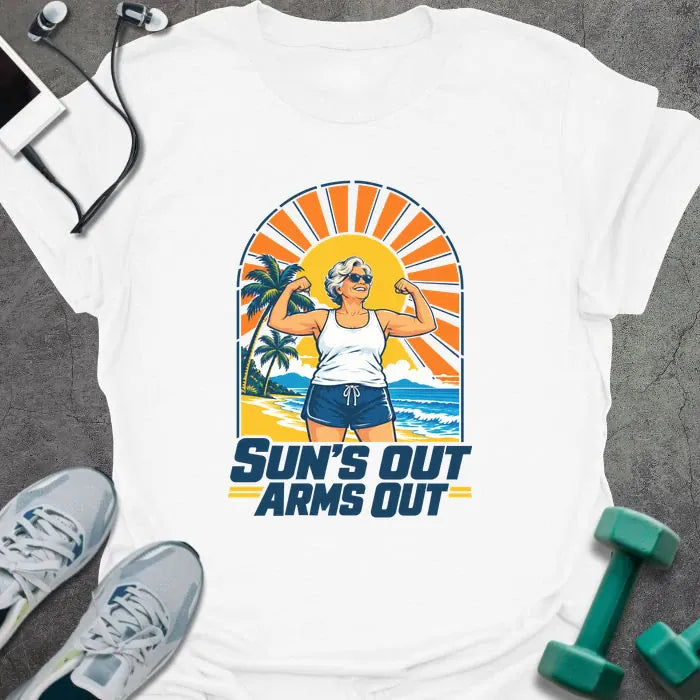 White t-shirt printed with "SUN'S OUT ARMS OUT" in navy blue, with a retro beach sunset and an older woman flexing her arms