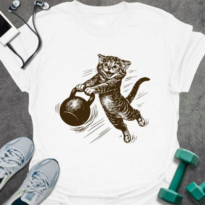 White t-shirt with a cat swinging a kettlebell in brown, tan