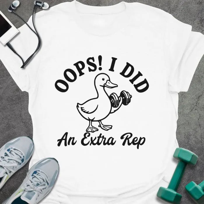 White t-shirt printed with "OOPS! I DID An Extra Rep" in black, with a duck holding a dumbbell