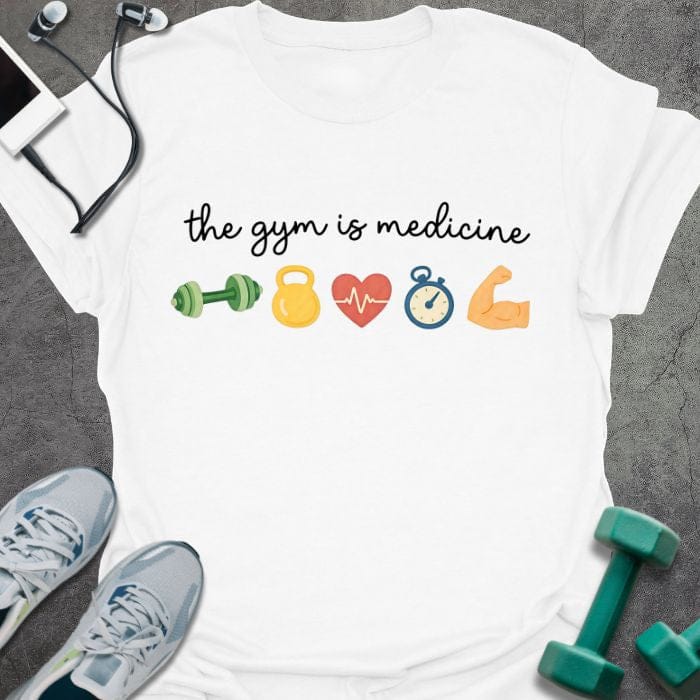 White t-shirt printed with "the gym is medicine" in multicolor, with emoji icons of gym equipment