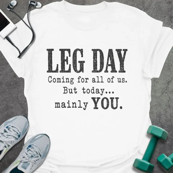 White T-shirt printed with "LEG DAY Coming for all of us. But today... mainly YOU." in brown