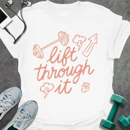 White t-shirt printed with "lift through it" in orange, with dumbbell, arrow up, fist graphics