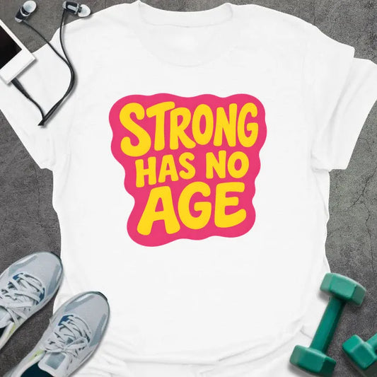 White t-shirt printed with "STRONG HAS NO AGE" in yellow and pink, with badge graphic