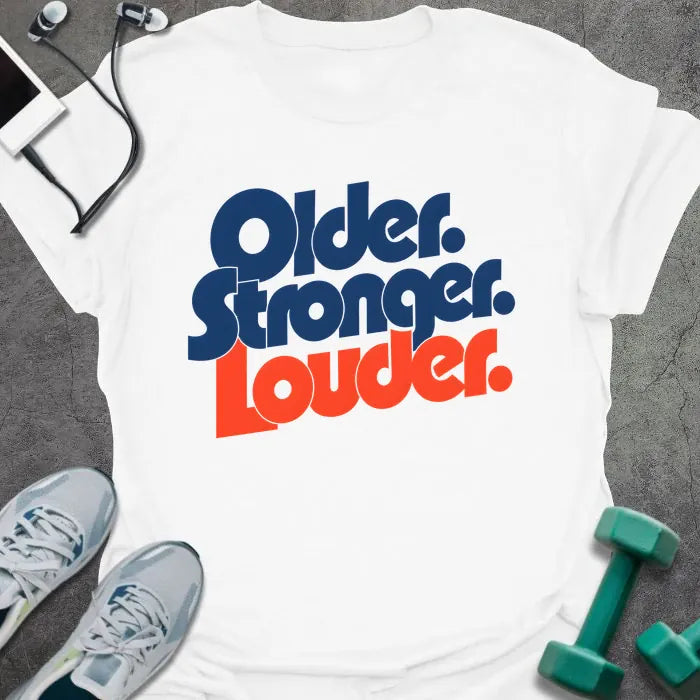 White t-shirt printed with "Older. Stronger. Louder." in navy blue with orange bold lettering