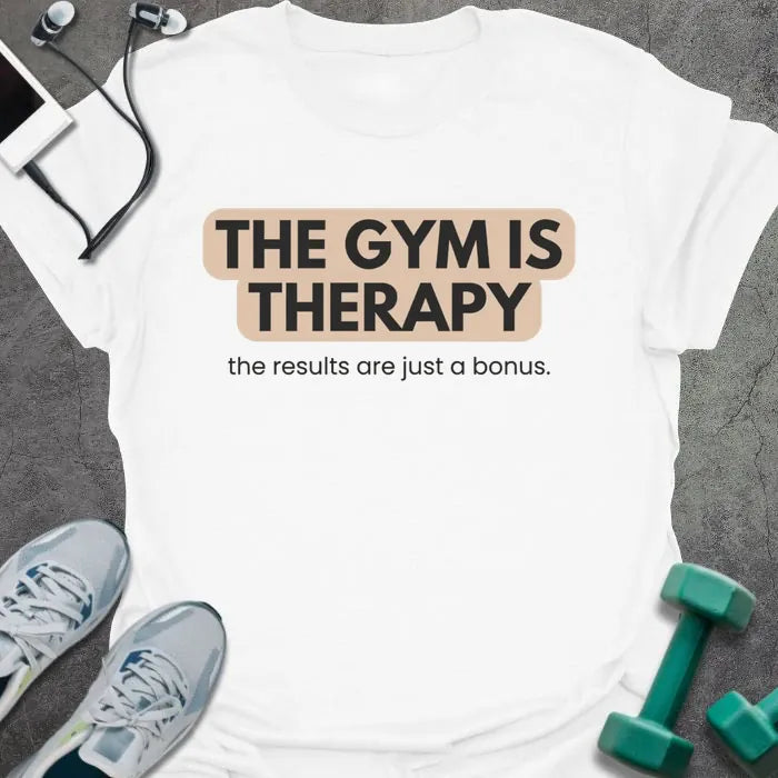 White t-shirt printed with "THE GYM IS THERAPY the results are just a bonus." in black and gray