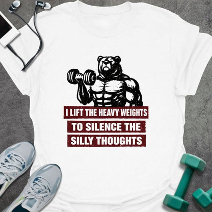White t-shirt printed with "I Lift the Heavy Weights to Silence the Silly Thoughts" in red and black, with muscular bear lifting dumbbell