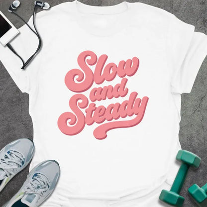 White t-shirt printed with "Slow and Steady" in rose and pink