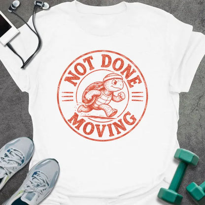 White t-shirt printed with "NOT DONE MOVING" in coral, with running turtle in circle