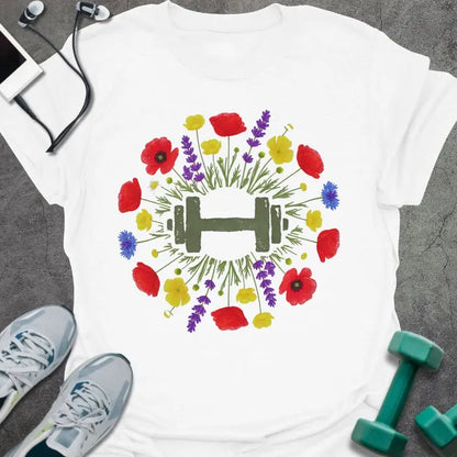 White t-shirt with an illustration of multicolor wildflowers surrounding a dumbbell in multicolor