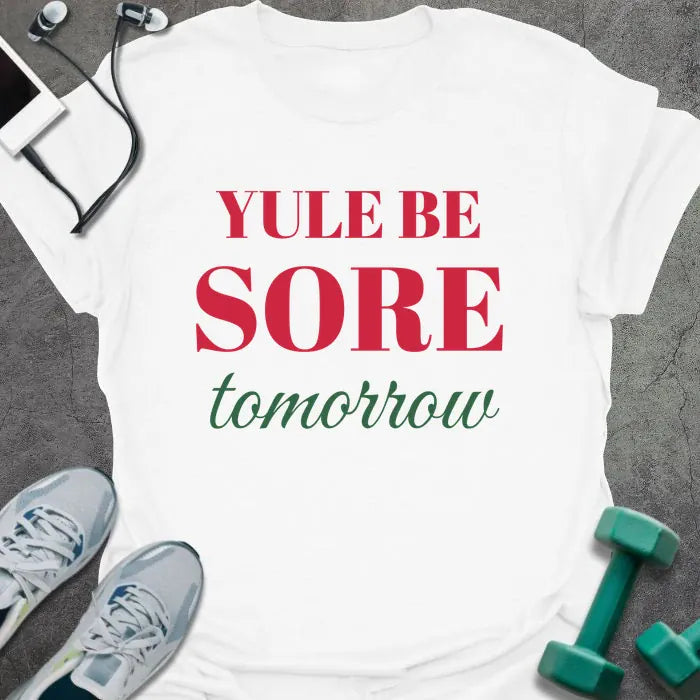 White t-shirt printed with "YULE BE SORE tomorrow" in red and green