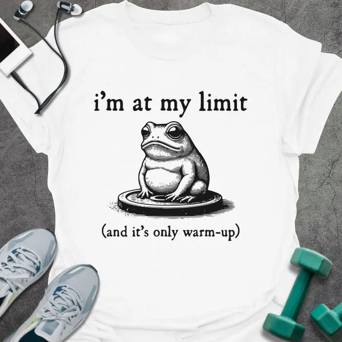 White t-shirt printed with "i'm at my limit (and it's only warm-up)" in black, with an illustration of a frog sitting