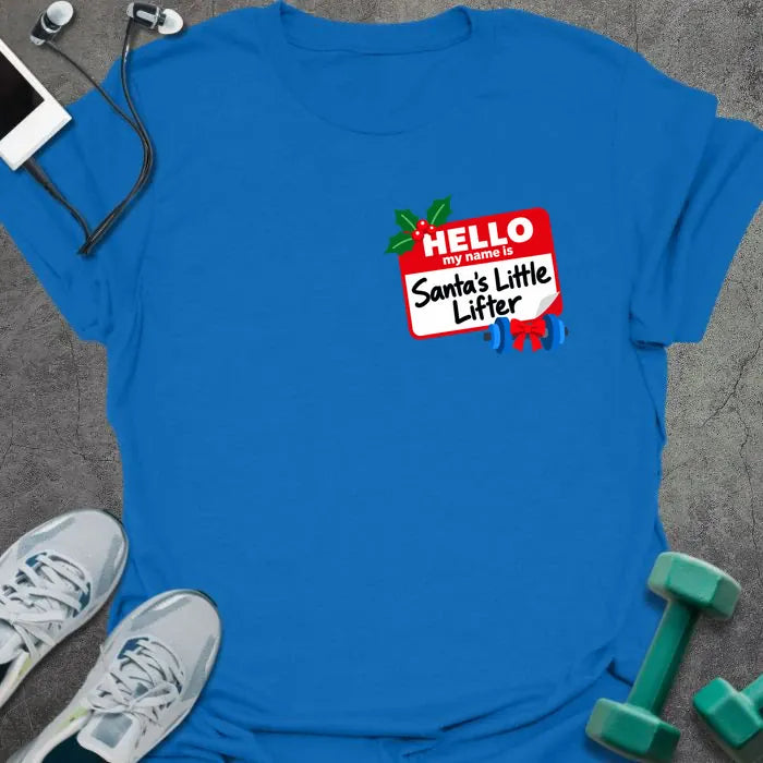 Royal blue t-shirt printed with a small red name tag on the chest reading "HELLO my name is Santa's Little Lifter", with holly and a blue dumbbell tied with a red bow