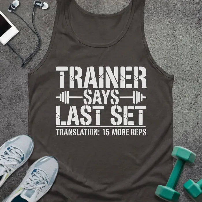 Dark grey tank top printed with "Trainer Says Last Set Translation: 15 More Reps" in white