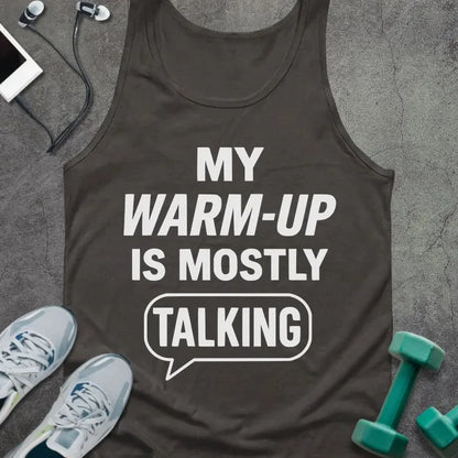 Dark grey tank top printed with "My Warm-up is Mostly (talking)" in white, with a speech bubble