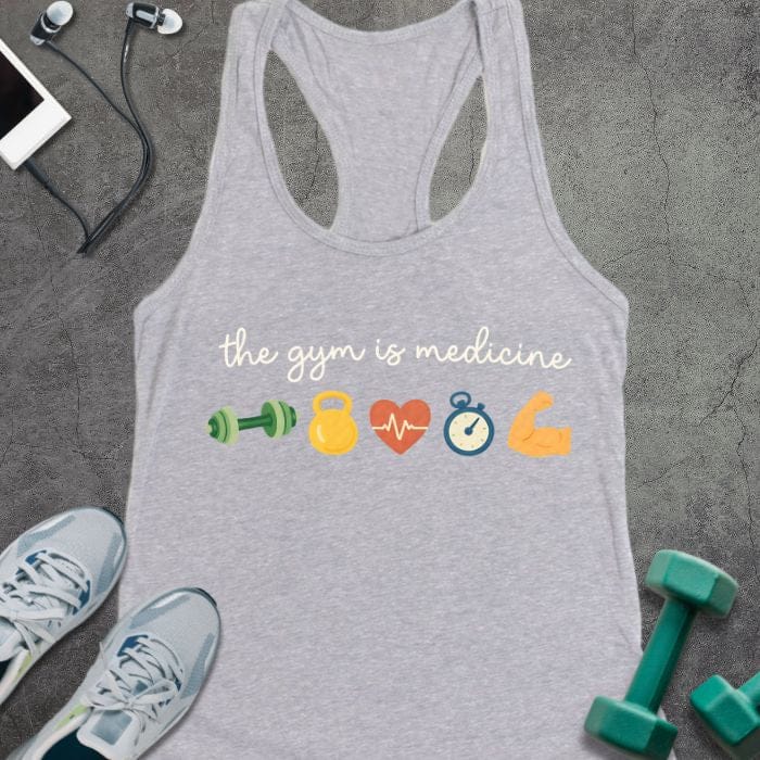 Heather grey tank top printed with "the gym is medicine" in white and multicolor, with colorful gym icons including dumbbells, kettlebell, heartbeat, and flexed arm