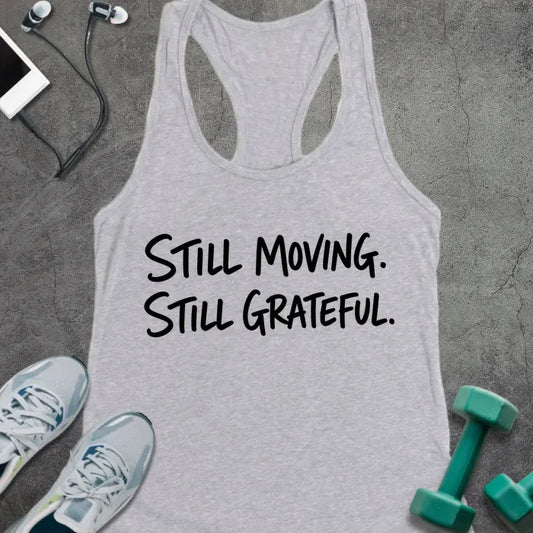 Heather Grey tank top printed with "STILL MOVING. STILL GRATEFUL." in black handwritten lettering