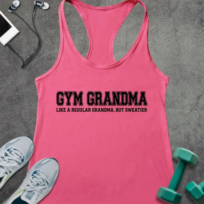 Hot pink racerback tank top printed with "GYM GRANDMA, LIKE A REGULAR GRANDMA, BUT SWEATIER" in black varsity letters