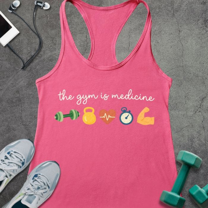 Hot pink tank top printed with "the gym is medicine" in white and multicolor, with colorful gym icons including dumbbells, kettlebell, heartbeat, and flexed arm