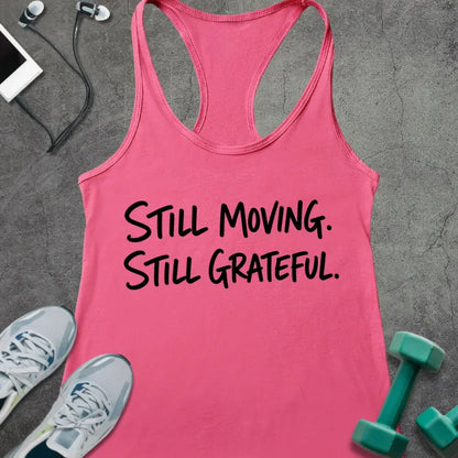 Hot Pink tank top printed with "STILL MOVING. STILL GRATEFUL." in black handwritten lettering