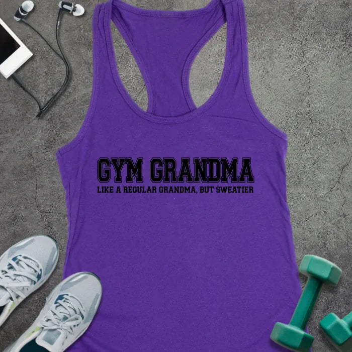 Purple racerback tank top printed with "GYM GRANDMA, LIKE A REGULAR GRANDMA, BUT SWEATIER" in black varsity letters