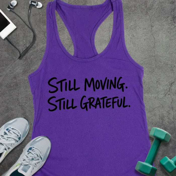 Purple Rush tank top printed with "STILL MOVING. STILL GRATEFUL." in black handwritten lettering
