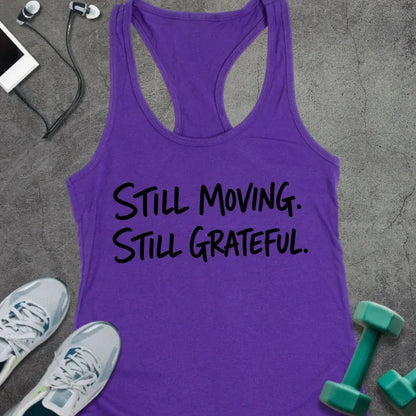 Purple Rush tank top printed with "STILL MOVING. STILL GRATEFUL." in black handwritten lettering