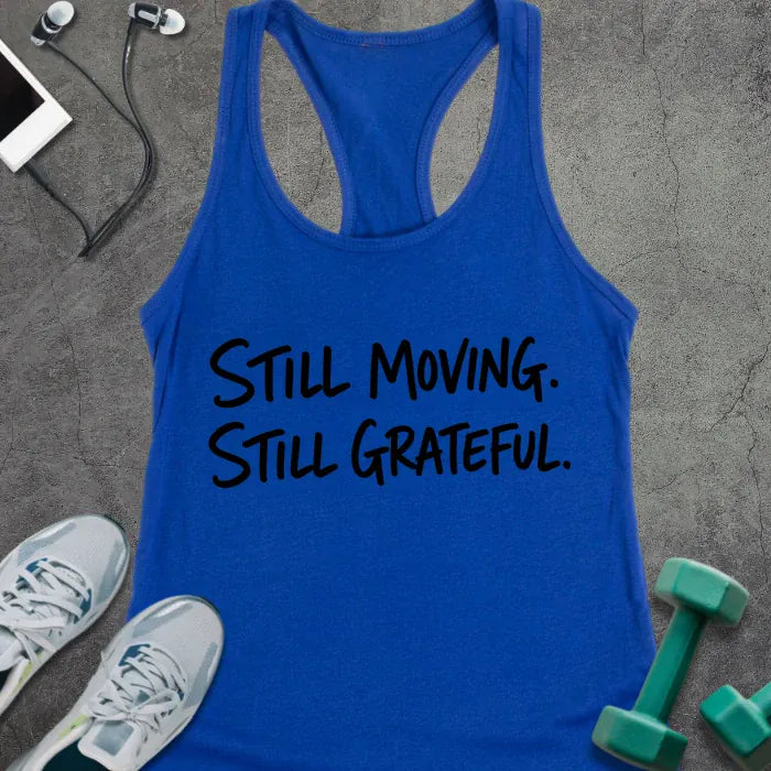 Royal tank top printed with "STILL MOVING. STILL GRATEFUL." in black handwritten lettering